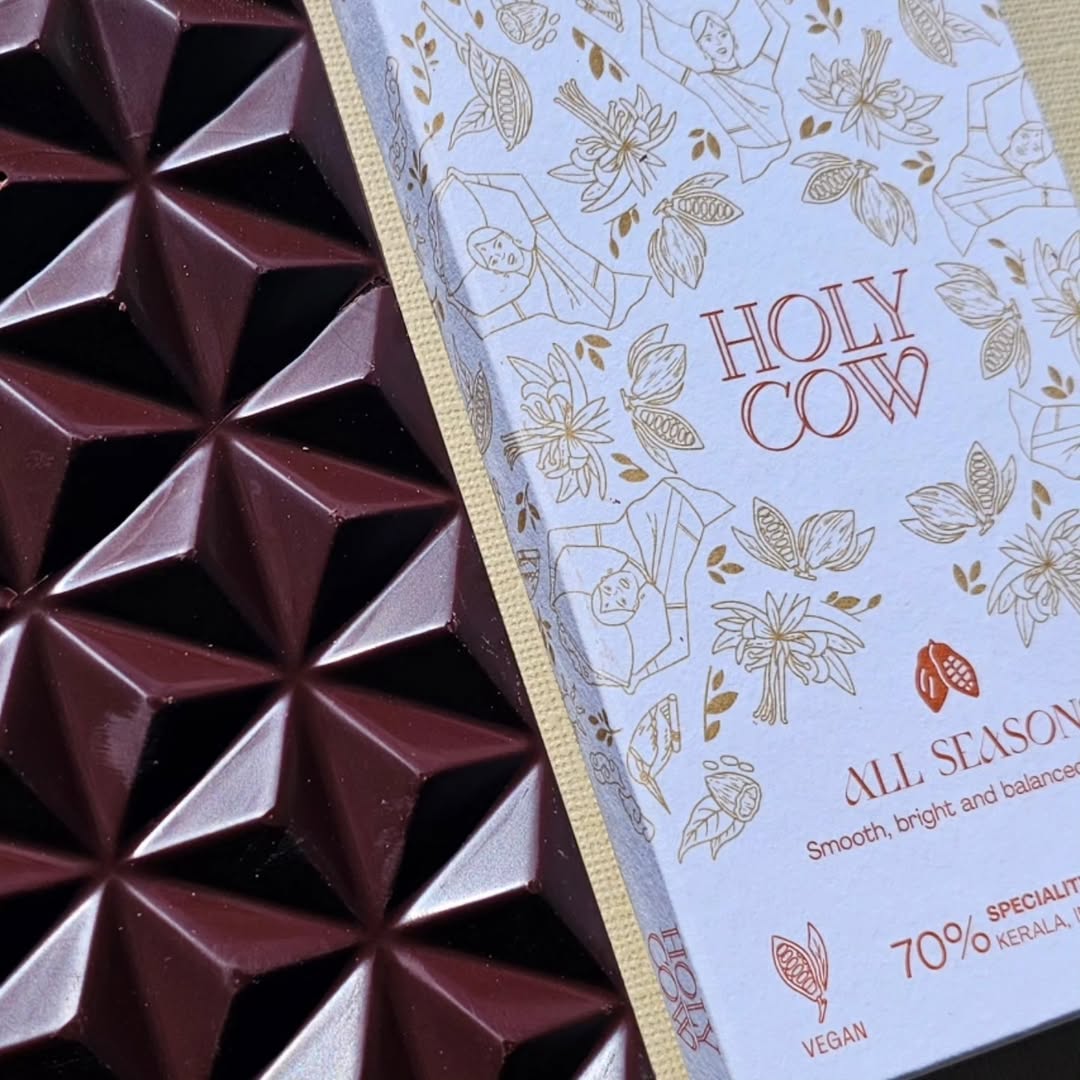 This one was wild! I love everything about this bar - the flavors AND the chocolate makers 🥰

I have to show my love for @holycow.gent chocolate's amazing mission and set up. Ellen and Luca are the makers behind these amazing bars, and what makes their chocolate unique is that they are a part of every link in their cocoa chain: from the farmers in India to their craft chocolate bars made in Belgium 😍

They founded GoGround Beans & Spices in 2015 in Udumbannoor - where they studied and perfected growing cacao beans to find their unique natural flavours 🍫

Not only are their bars made from cacao beans grown in Kerala, India - they also highlight the season the beans were grown in! They have a:

✨ Monsoon Season Bar
✨ Dry Season Bar
✨ All Seasons bar

How awesome is that 🤯

The bar I'm tasting is their All Seasons bar and its "wild" because it starts off with chocolatey woody flavours and then completely transforms 😍

Honey flavours introduce themselves and the melt is seamless. You also get a warm butterscotch flavour (which really compliments that honey) and just when you thought it was safe to enjoy the molten, buttery goodness, a lemon note weaves its way through - brightening the whole experience ✨

Each flavor is so distinct - especially that honey butterscotch and that sneaky hint of lemon 😍

I'll have to be back to revisit because I'm so so so curious about their Dry and Monsoon season chocolate bars (and might be an excuse to get another All Seasons while I'm at it 😉))

You can find @holycow.gent chocolate on their website: https://holycow-chocolate.be/ (they ship to Belgium, Germany, France, Italy, Luxembourg, The Netherlands and Spain!)

There are also several stockists in Belgium - check out their Points Of Sale / Verkooppunten page 🥳

Have you tried any of the @holycow.gent chocolate range? Have you had a chance to try chocolate bars made from beans grown in the same location but during different seasons?

#smallbatch #chocolatereviews #chocolatetasting