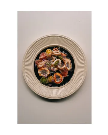S Q U I D

Another icon from the last weeks. Encornet or baby squid is fished in La Rochelle’s renowned Bay of Biscay. A sauce made from squid viscera, sofrito, tomato, wine, fresh oregano, lemongrass and ginger is reduced with ink to create the base. We accompany the grilled squid with cherry tomatoes from famed Philip Vermeulen - who has been growing organic tomatoes since 1999. These are peeled and seasoned with Xerex vinegar, fleur de sel and olive oil. On top, cured kintoa pork belly, a Basque delicacy made from the free range Pie Noir breed. The meat is dry aged using salt from the Adour basin, thinly cut and lightly melted. To finish either chive flowers 📷, sea fennel, or this week fresh fennel seeds and finally lovage oil!

Thanks to all our suppliers for such incredible ingredients that allow us to make these beautiful dishes!

📸@boogy_blow