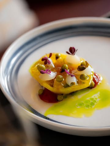 Tomato & onion, inspired by a classic Polish side dish. A memory of Polish summers, slightly twisted.

Unripe blackcurrants become capers. Young branches become oil. Herring brings the sea, while the tomato brings the sun.
Fat, salt, acidity and a touch of floral magic - all there to make the tomato sing a little louder.

Still here for now. But summer doesn’t wait.

Photo @marjorie_romeijn