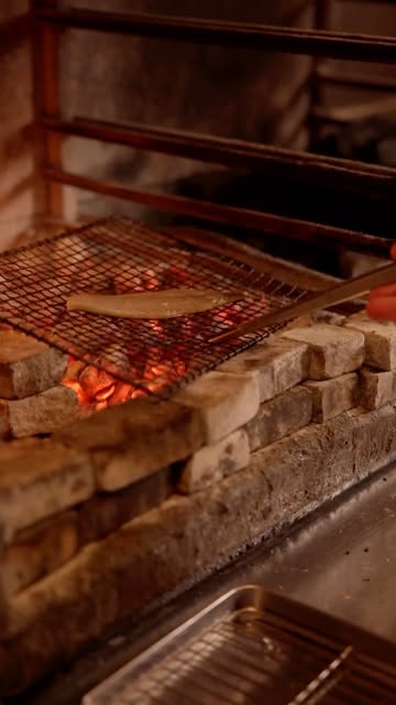 Preparation of grilled mackerel & lovage on our open fire.